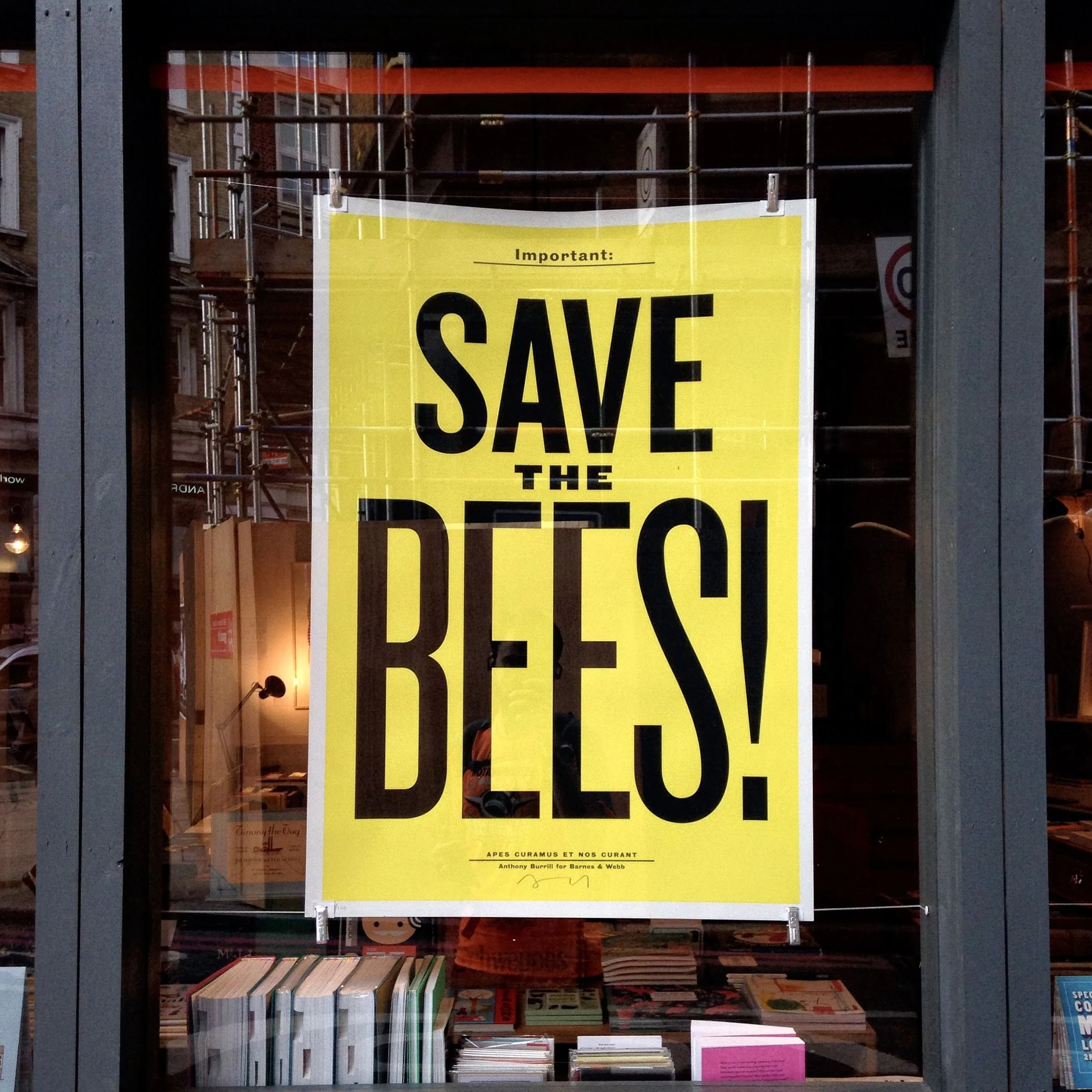 A yellow poster reading Save Bees
