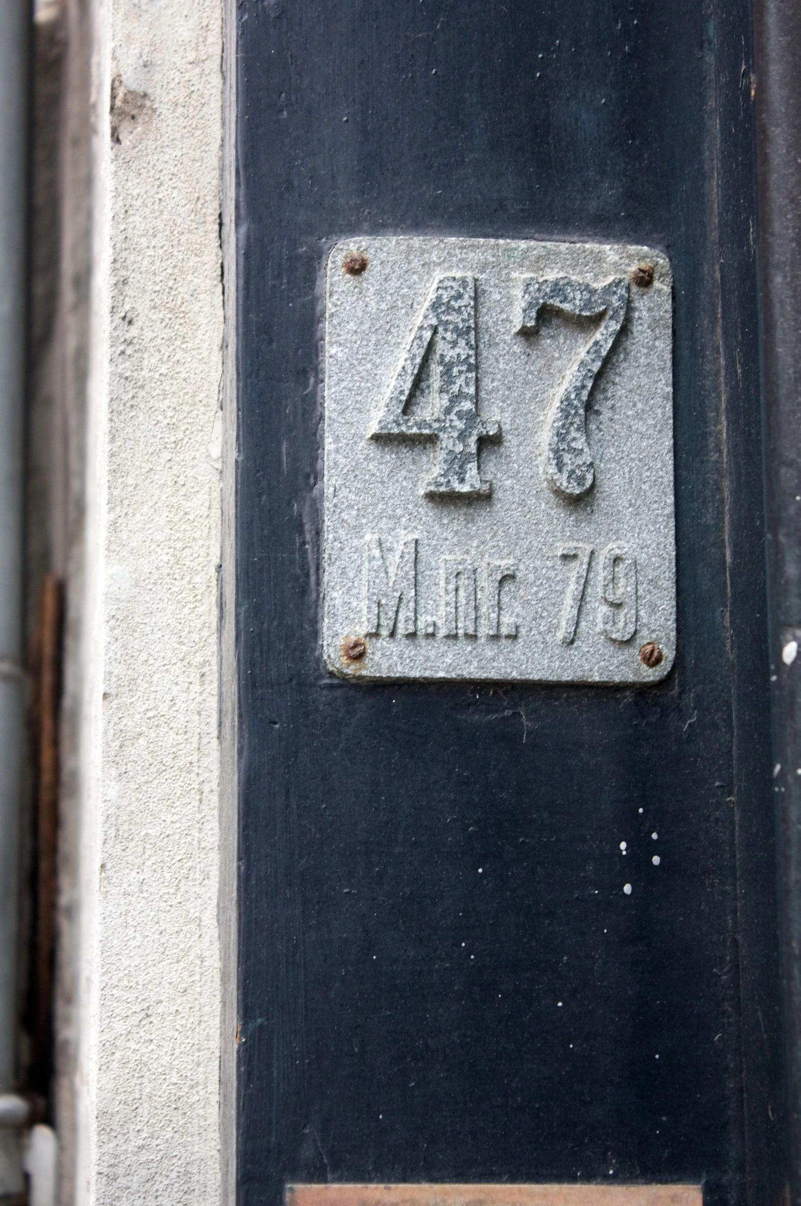 The number 47 on a dark door