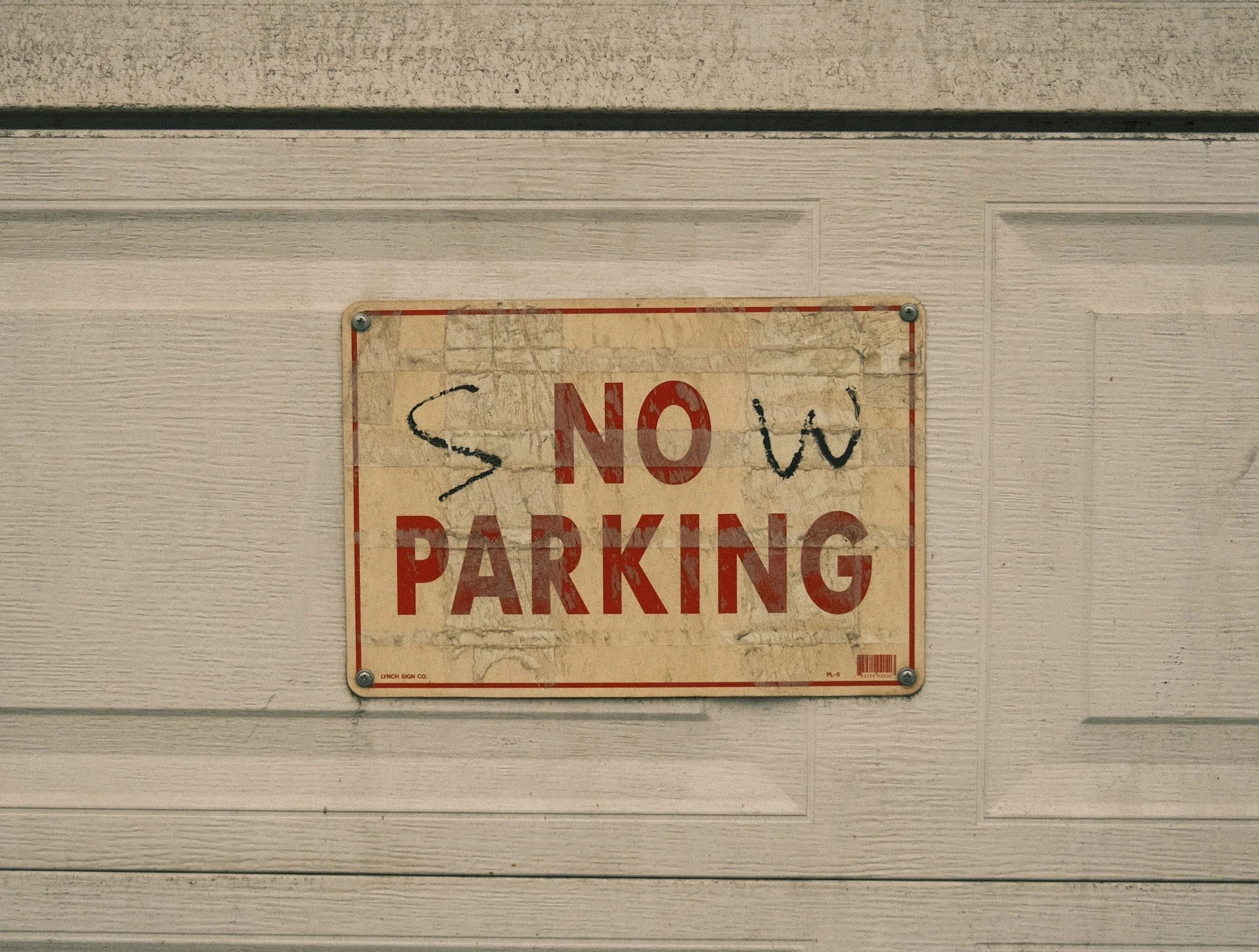 A faded No Parking sign