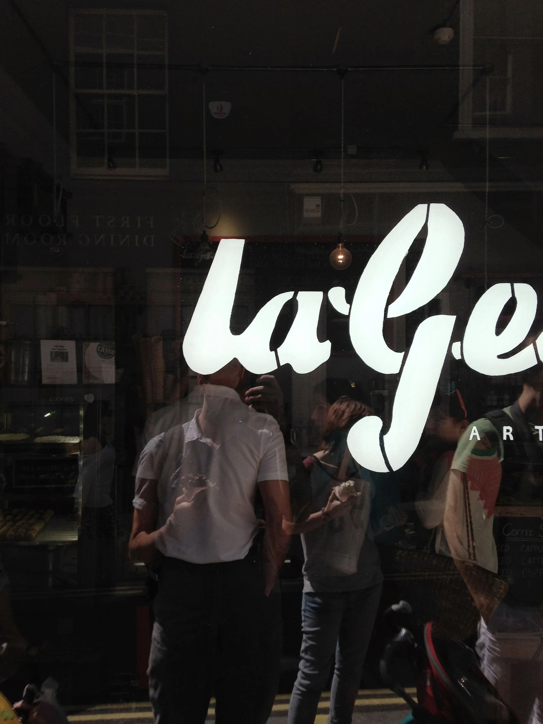 White script lettering on a dark window