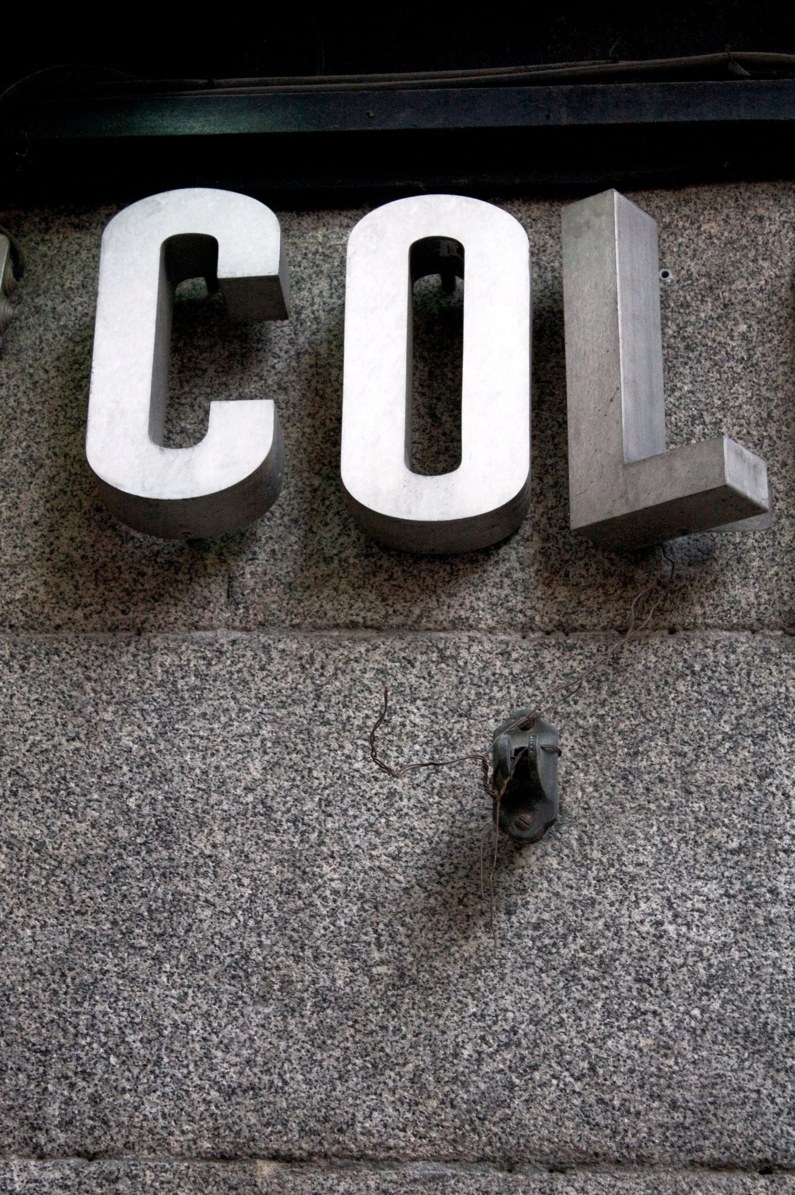 White block letters on a weathered wall