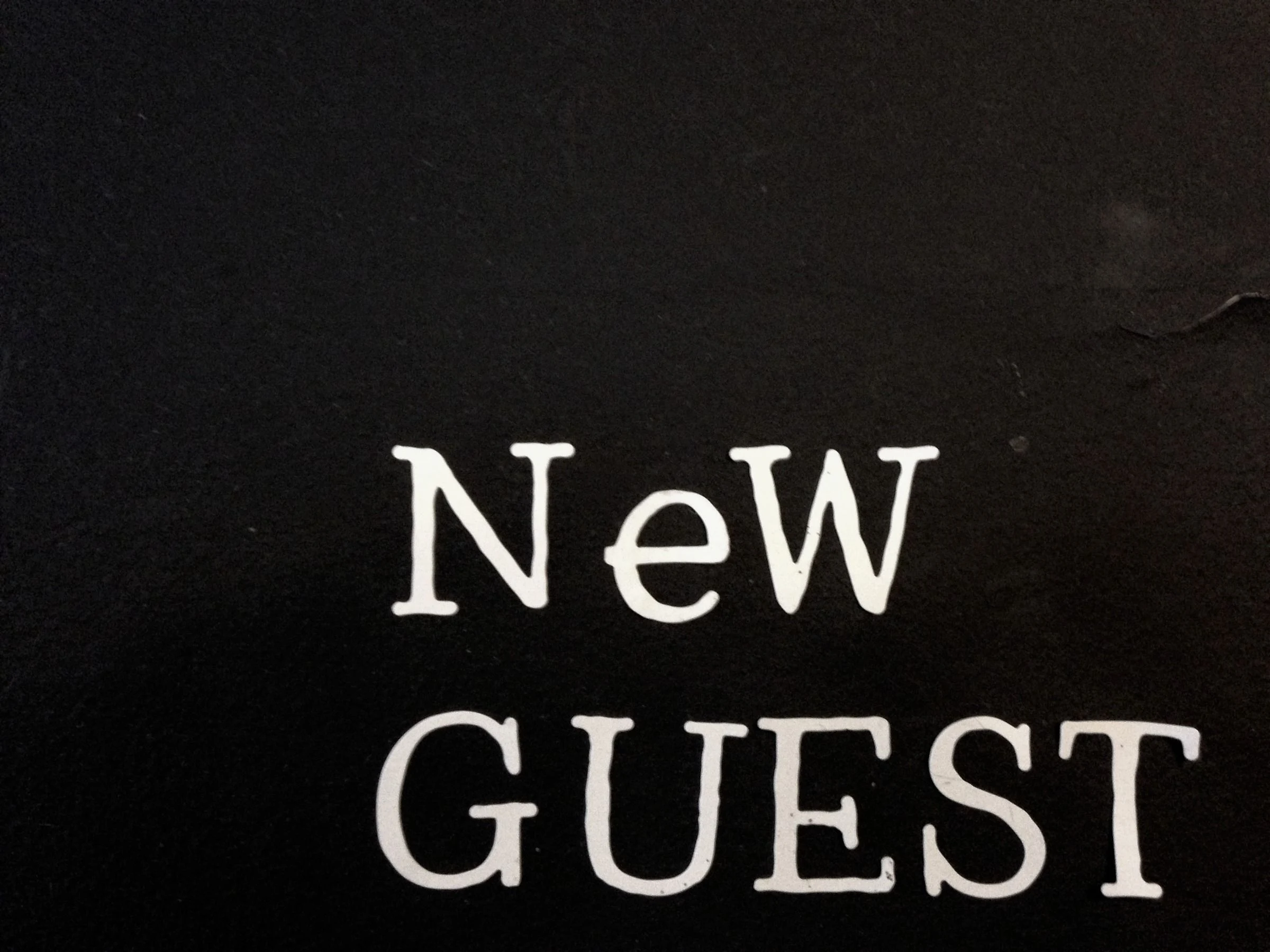 White lettering reading New Guest