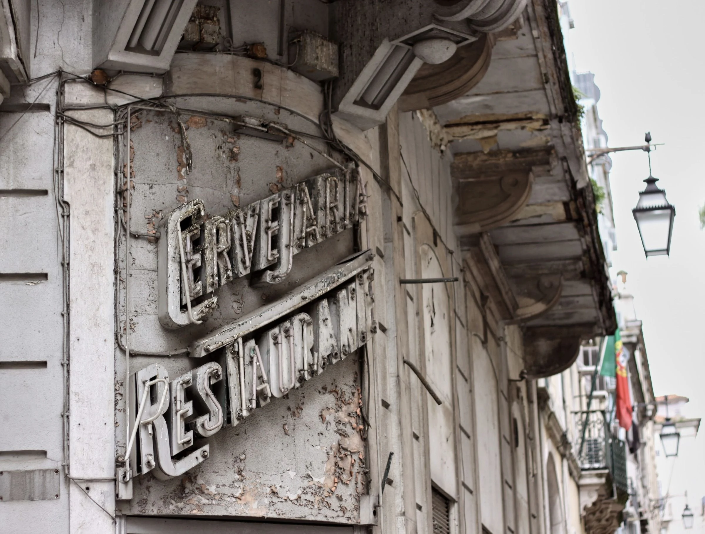 Carved and painted lettering on a building corner