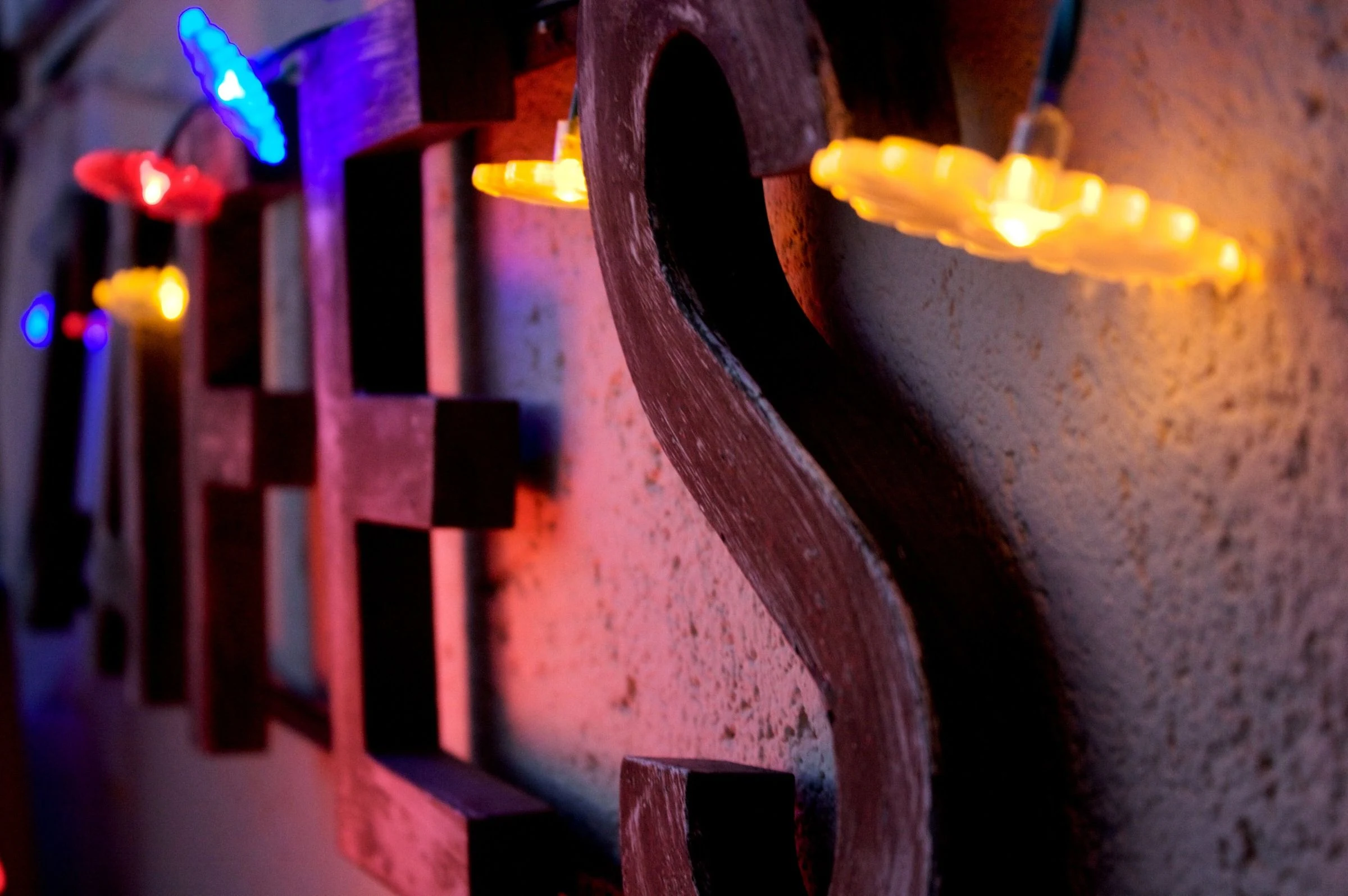 Colorful neon lettering reflected on a wall