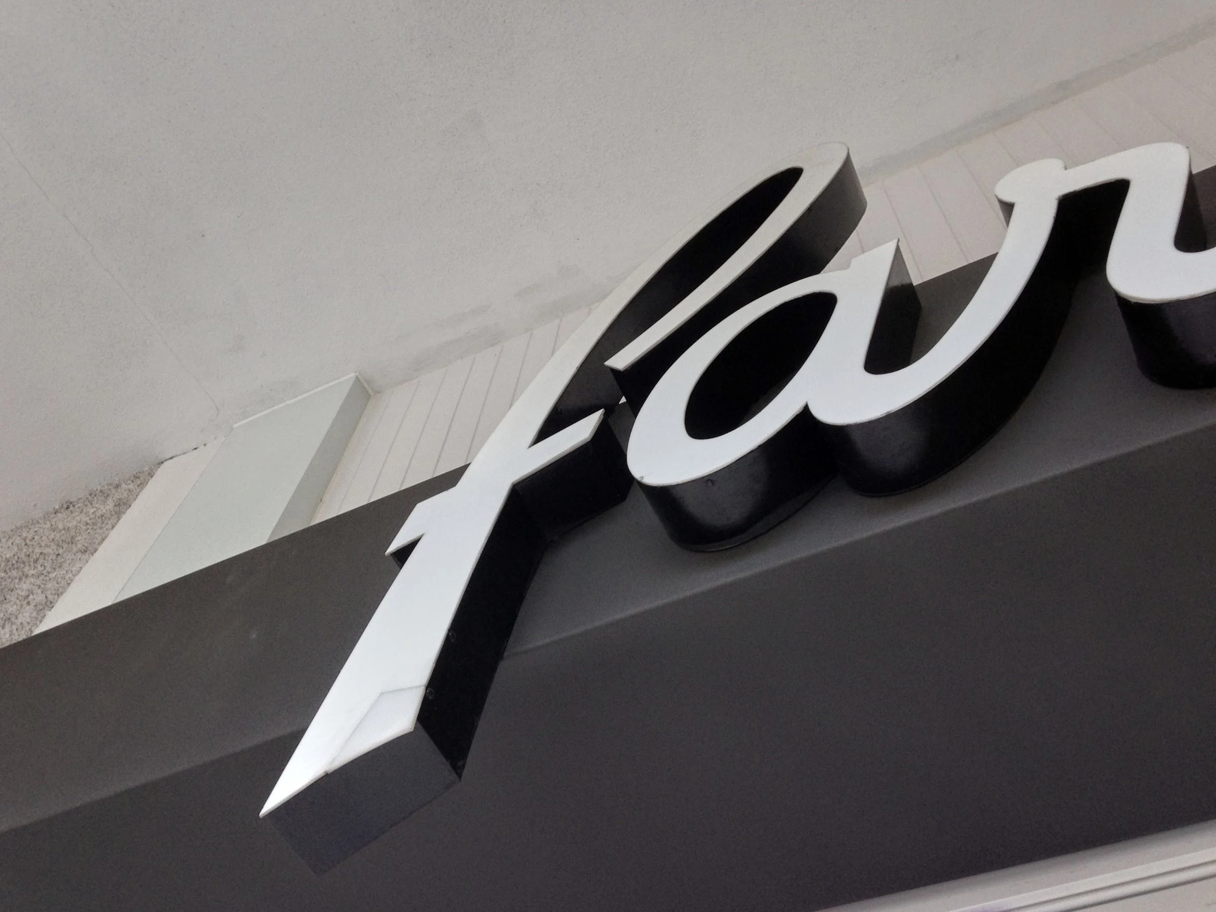 White script lettering on a gray facade