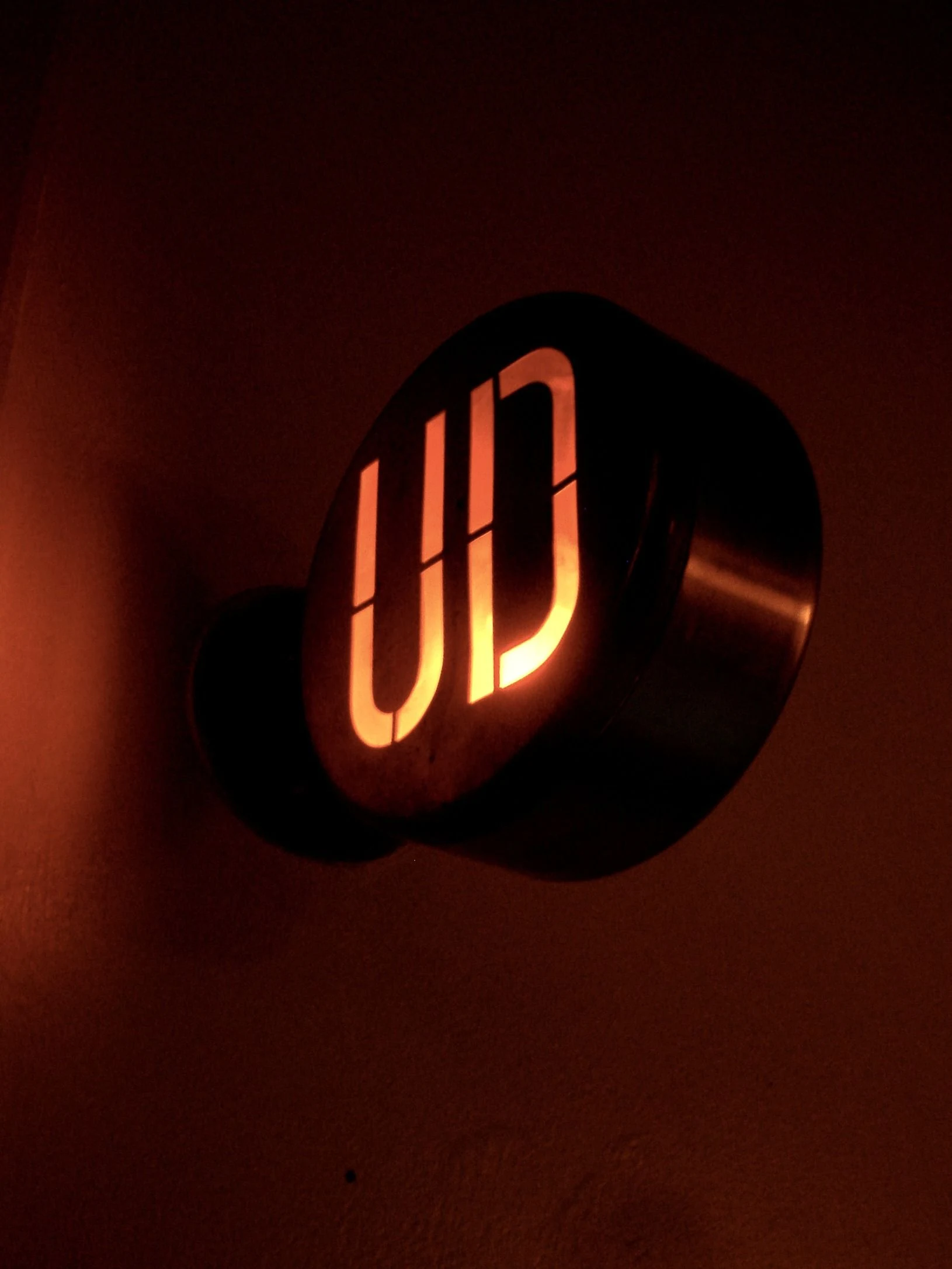 Warm illuminated letters on a dark projecting sign