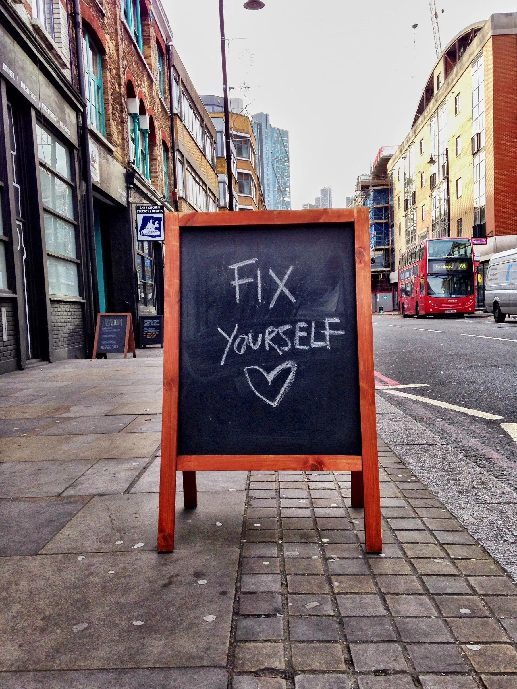A chalkboard standing on the pavement
