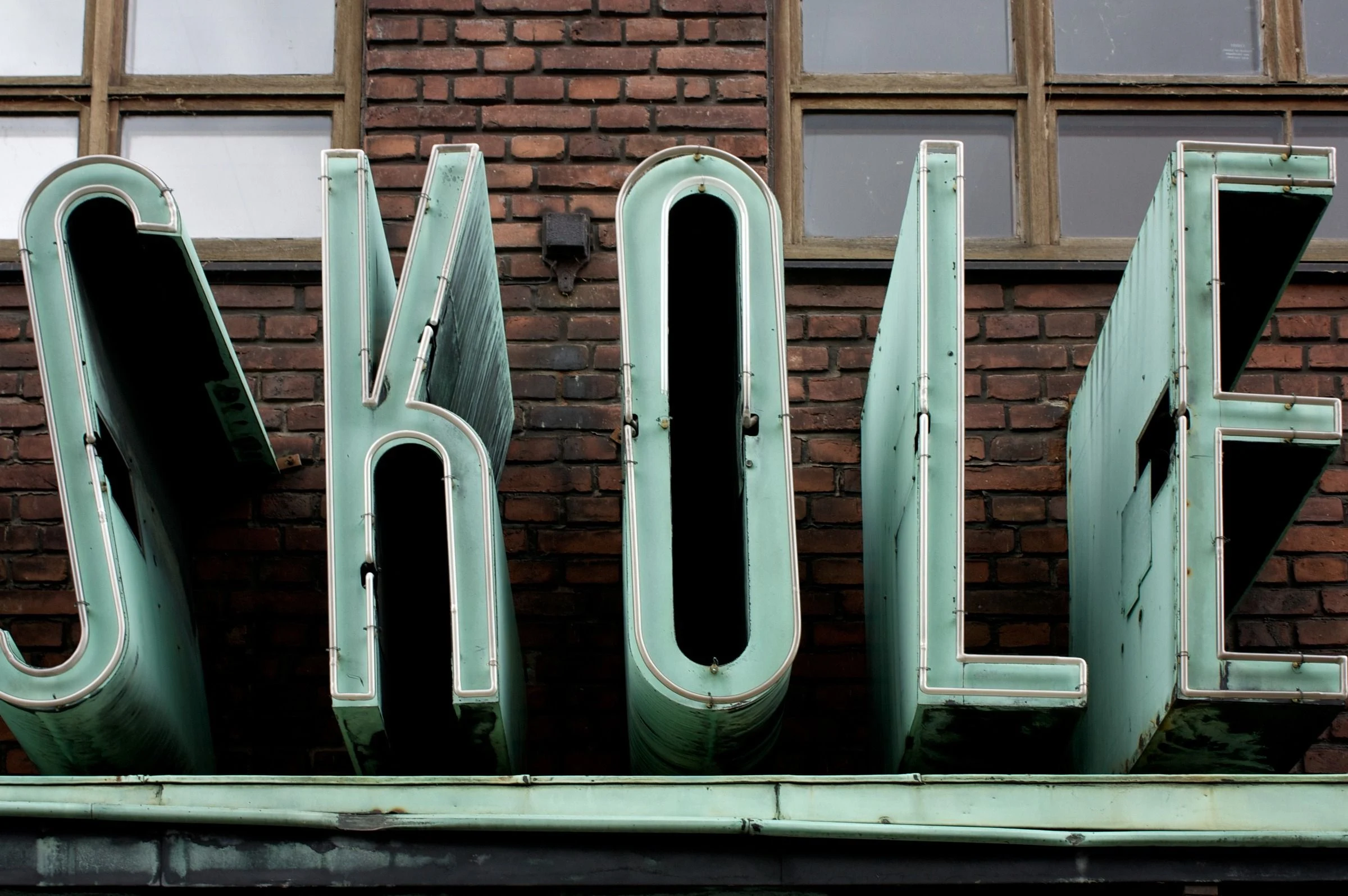 Tall pale letters across a shop window